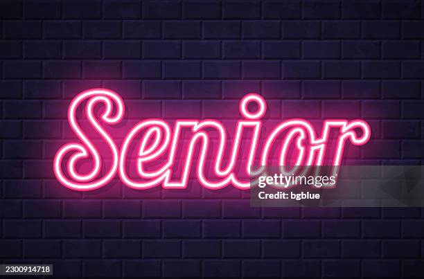 senior - glowing neon text on brick wall background - high school administration stock illustrations