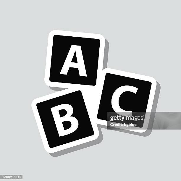 scattered abc blocks. icon sticker on gray background - white cube stock illustrations