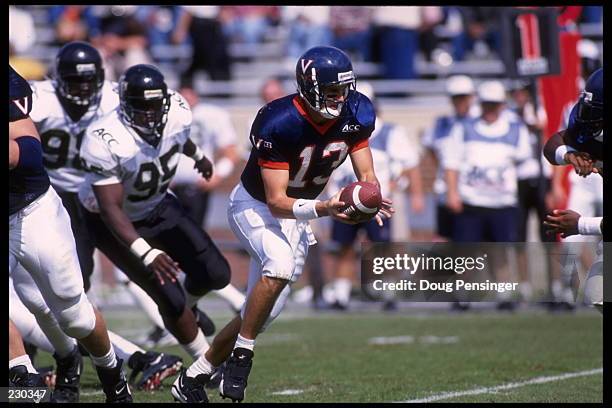 WAKE FORREST QUARTERBACK MIKE GROH TURNS TO HAND OFF DURING THE DEMON DEACONS 35-17 LOSS TO THE VIRGINIA CAVALIERS AT SCOTT STADIUM IN...