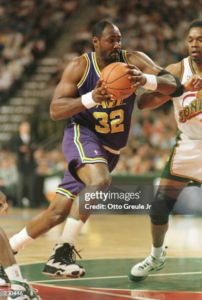 Karl Malone of the Utah Jazz drives to the basket for two of his team high 32 points against the Seattle Supersonics during first half action in Game...