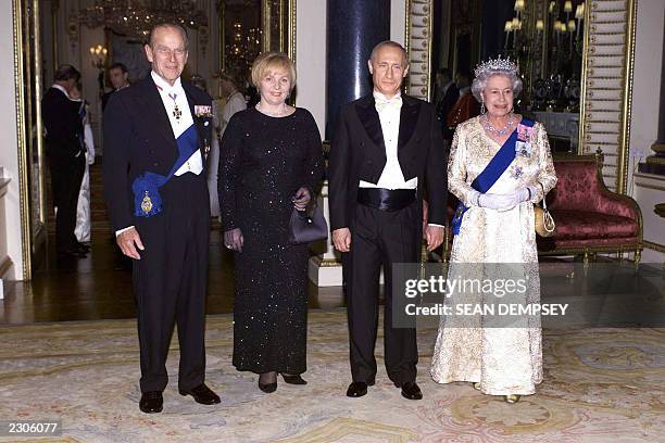 Britain s Queen Elizabeth II and her husband, the Duke of Edinburgh stand alongside Russia s President Putin and his wife, Lyudmila, before a state...