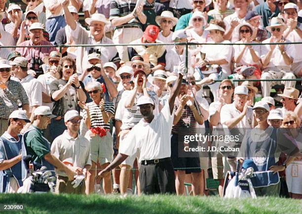 Vijay Singh of Fiji raises his arm in celebration after holing out from the tee on the 14th hole for a hole in one during the second round of play in...