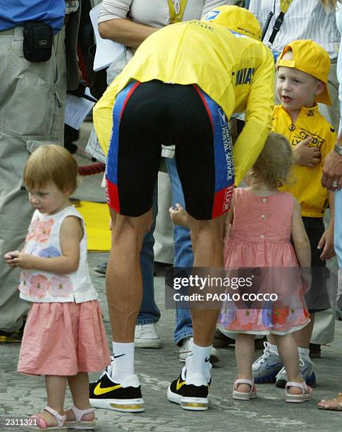 Lance Armstrong jokes with his children, son Luke and daughters Isabelle and Grace at the end of the 20th and last stage of the 90th Tour de France...