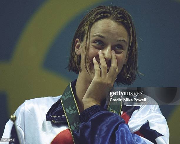 Amanda Beard of the USA enjoys her gold medal for the 4 x 100 medley relay event at the Georgia Tech Aquatic Center at the 1996 Centennial Olympic...