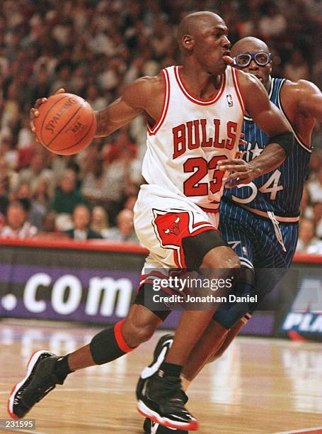 Guard Michael Jordan of the Chicago Bulls drives around forward Horace Grant of the Orlando Magic during the third quarter of game one of the Eastern...