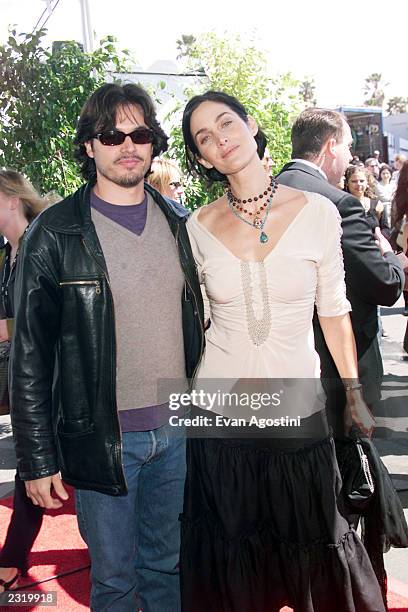 Actress Carrie-Anne Moss with husband Steven Roy arriving on a motorcycle at the 2002 IFP/West Independent Spirit Awards at the beach in Santa...
