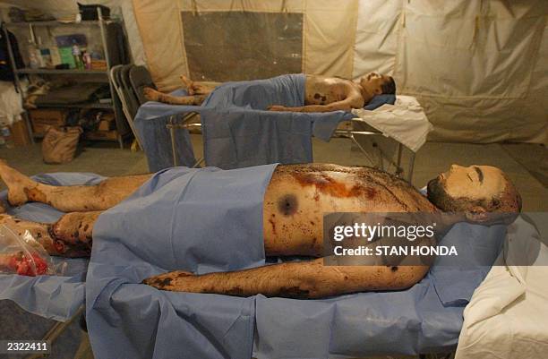 Two bodies said to be the corpses of former dictator Saddam Hussein's two sons Uday and Qusay, who US forces announced were killed in a fierce gun...