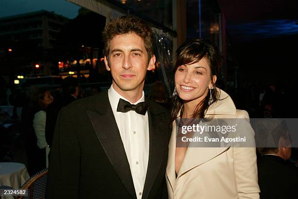 Dir. Alexander Payne and Gina Gershon at the "About Schmidt" Pre-Premiere party at Carlton Beach during the 55th Cannes Film Festival in Cannes,...