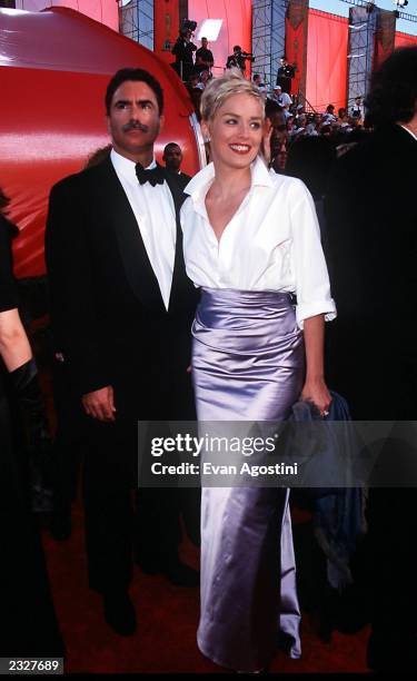 70th ANNUAL ACADEMY AWARDS AT THE SHRINE AUDITORIUM ARRIVALS: SHARON STONE AND HUSBAND PHOTO: Evan Agostini/Getty Images