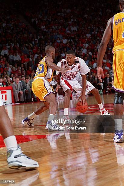 ARKANSAS RAZORBACKS FORWARD SCOTTY THURMAN DRIBBLES THE BALL DURING A SOUTHEASTERN CONFERENCE GAME AGAINST THE LOUISIANA STATE TIGERS.