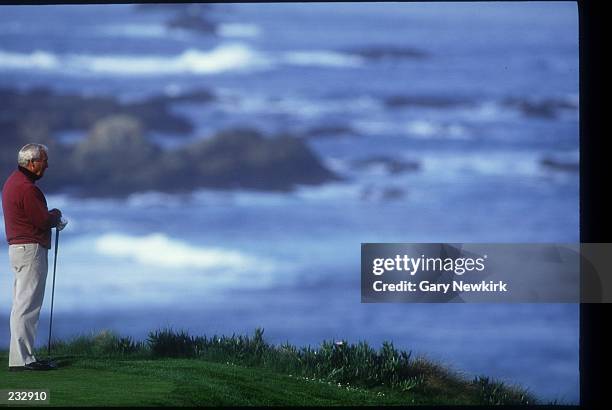 ARNOLD PALMER TAKES A MOMENT TO ENJOY THE SCENERY WHILE WAITING TO TEE OFF ON THE 4TH HOLE AT SPYGLASS GOLF COURSE DURING THE AT&T PEBBLE BEACH...