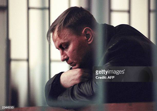 Russian Colonel Yuri Budanov charged with murder in the strangling of a young Chechen woman, sits in the defendant's box during his trial at...