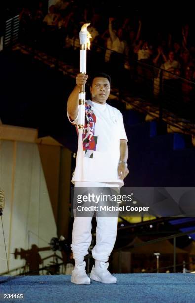 Muhammad Ali holds the torch before lighting the Olympic Flame during the Opening Ceremony of the 1996 Centennial Olympic Games in Atlanta, Georgia....