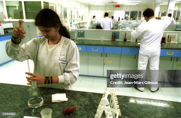 Technicians work at a Cipla laboratory March 3, 2002 in Vikhrohi, Mumbai, India. Cipla, the second largest pharmaceutical company in India, has...