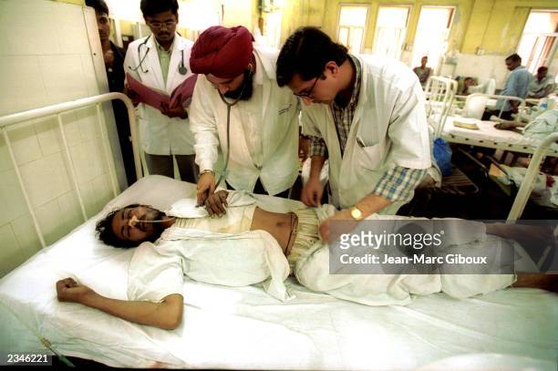 Doctor examines an AIDS patient March 11, 2002 at Lokmanya Tilak Hospital in Mumbai, India. AIDS patients are placed with other patients, as there...