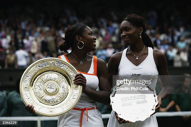 Serena Williams of the USA looks across to her sister Venus Williams of the USA after her victory in the Womens Singles Final during day twelve of...