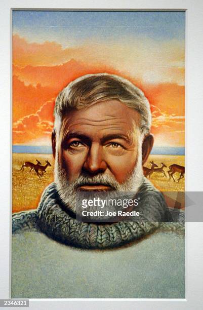Portrait of Ernest Hemingway hangs on the wall during the opening of the Art of the Stamp exhibition at the Smithsonian National Postal Museum July...