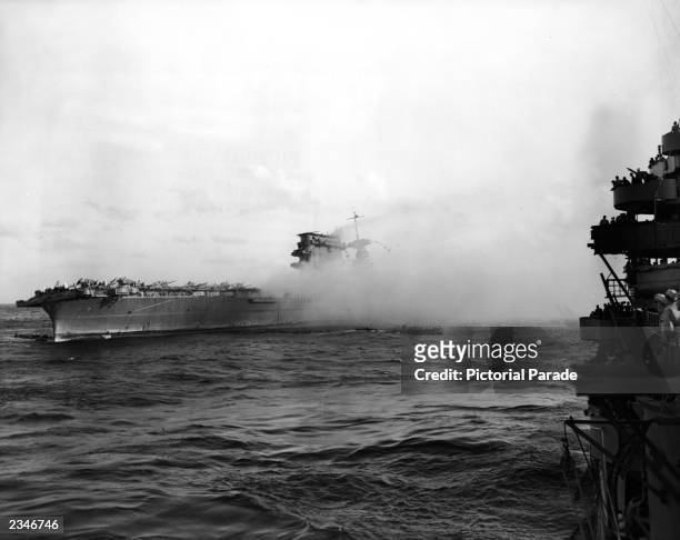 Smoke pours from the aircraft carrier the USS Lexington from Japanese torpedo hits during the Battle of the Coral Sea in World War II, 1942.