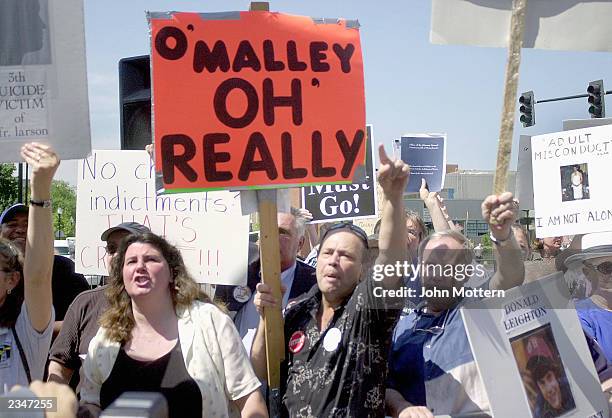 Protesters shout at Sean Patrick O'Malley as he walks into the Cathedral of the Holy Cross during his installment as the new Roman Catholic...