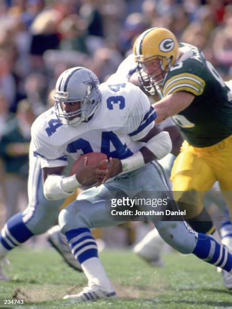 Running back Herschel Walker of the Dallas Cowboys makes a cut up field to avoid the pursuing defense of the Green Bay Packers during the Cowboys...