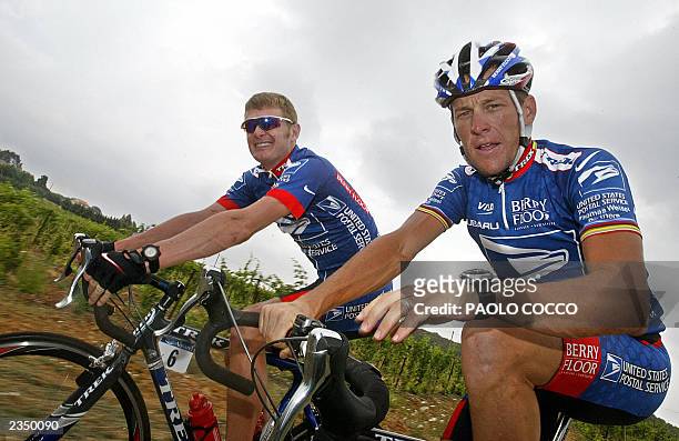 Lance Armstrong rides alongside with his teammate US Floyd Landis during a rest day of the 90th Tour de France cycling race, 16 July 2003 around...