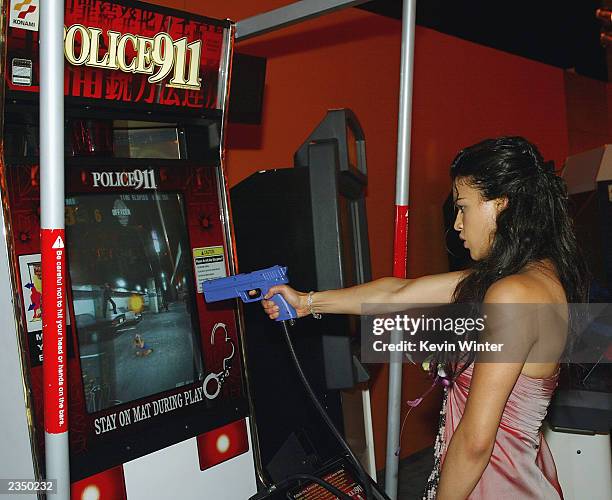 Actress Michelle Rodriguez plays a video game at the after-party for "S.W.A.T." on July 30, 2003 in Los Angeles, California.