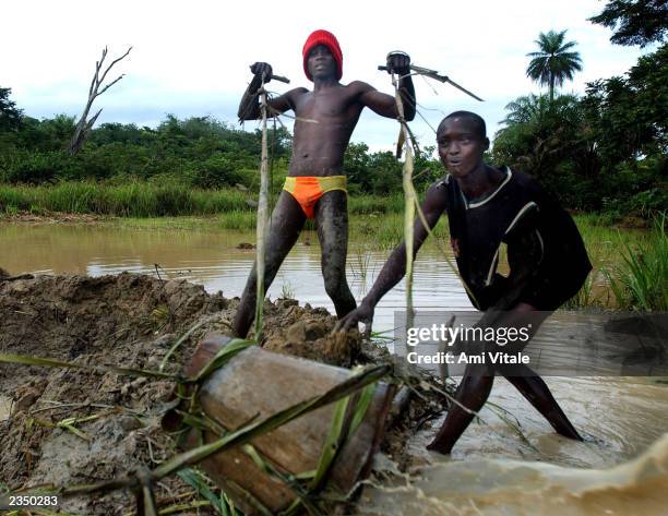 Children illegally dig for diamonds in the eastern part of Sierra Leone, Africa, July 22, 2002.