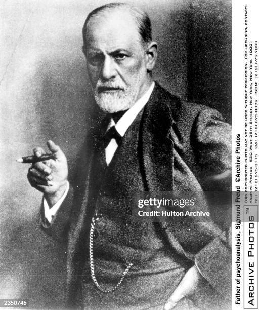 Austrian psychoanalyst Sigmund Freud smoking a cigar, c. 1920.