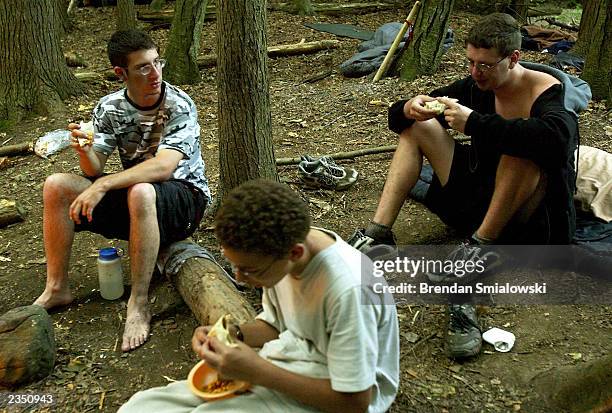 Students eat while camping out at the Center for Attention and Related Disorders? camp at the Great Hollow Wilderness School July 30, 2003 in New...