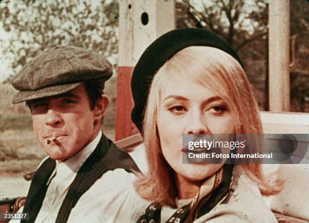 American actors Warren Beatty and Faye Dunaway sit in a car in a still from the film, "Bonnie And Clyde," directed by Arthur Penn, 1967.
