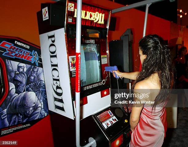 Actress Michelle Rodriguez plays a video game at the after-party for "S.W.A.T." on July 30, 2003 in Los Angeles, California.