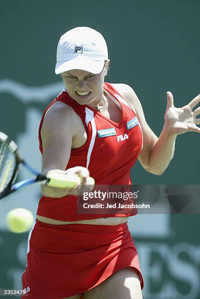 Kim Clijsters of Belgium returns a shot against Marie-Gaianeh Mikaelian of Switzerland during the quaterfinals of the Bank of the West Classic at...