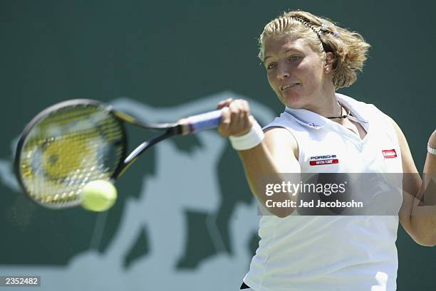 Marie-Gaianeh Mikaelian of Switzerland returns a shot against Kim Clijsters of Belgium during the quaterfinals of the Bank of the West Classic at...