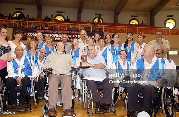 Christopher Reeve poses with members of the "Hora on Wheels" dance troupe from Beit HaLochem Rehabilitation Center July 31, 2003 in Tel Aviv, Israel....