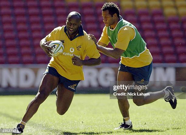 Wendell Sailor is caught by Lote Tuqiri during the Australian Wallabies Captains Run held at Suncorp Stadium August 1, 2003 in Brisbane, Australia.