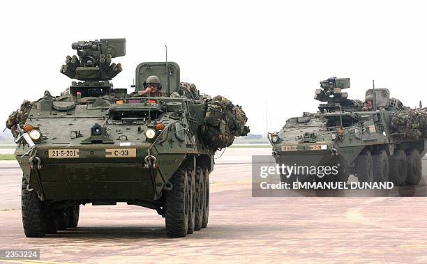 Two Stryker infantry carrier vehicles, the US Army's newest light armored vehicle, drive onto a tarmac, 31 July 2003, upon arrival at Osan US Air...