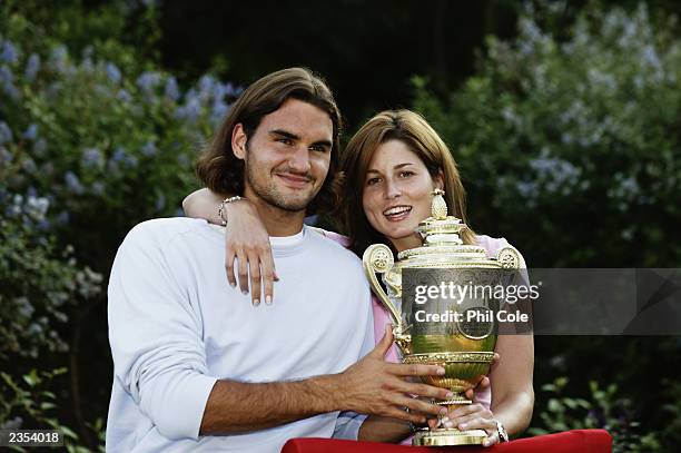 Men's Singles champion Roger Federer of Switzerland poses with his girlfriend Miroslava Vavrinec and the trophy after his victory over Mark...