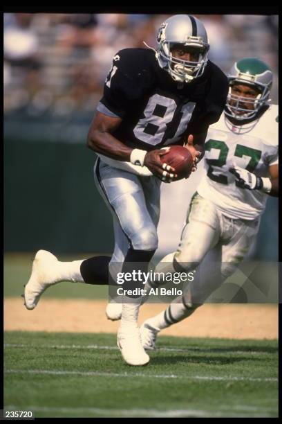 Wide receiver Tim Brown of the Oakland Raiders looks up field as he runs down the sideline following a reception in the Raiders 48-17 victory over...