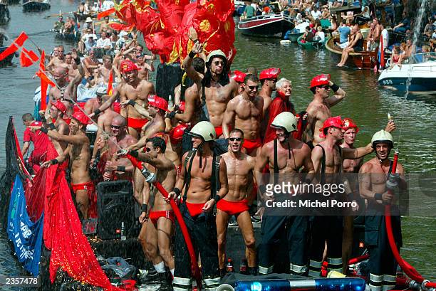 Members of the Dutch gay community participate in the annual Gay Pride parade through the canals August 2, 2003 in Amsterdam, Netherlands. The event...
