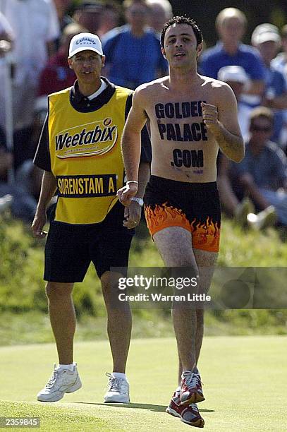 Annika Sorenstam's caddie chases off a streaker on the 15th green during the final round of the Weetabix Womens British Open with a score of 10 under...