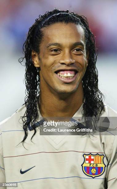 Ronaldinho of Barcelona is all smiles as he is booed by Manchester United fans during the team line-ups during the Champions World Series game...