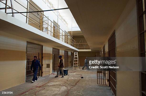 Iraqi workers help renovate the former Abu Ghraib prison August 4, 2003 in Baghdad, Iraq. Which is being cleaned and renovated by the 94th Engineer...