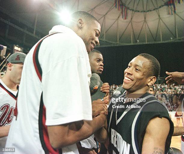 Center Marcus Camby of the UMass Minutemen shakes hands with point guard Allen Iverson of the Georgetown Hoyas following the Minutemen''s 86-62 NCAA...