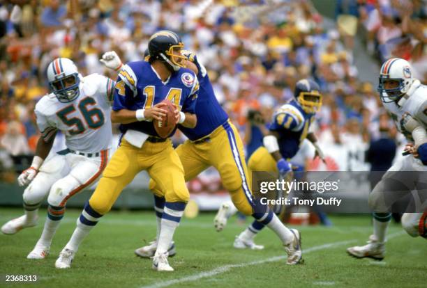 Quarterback Dan Fouts of the San Diego Chargers looks to pass during a game against the Miami Dolphins at Jack Murphy Stadium during the 1983 NFL...