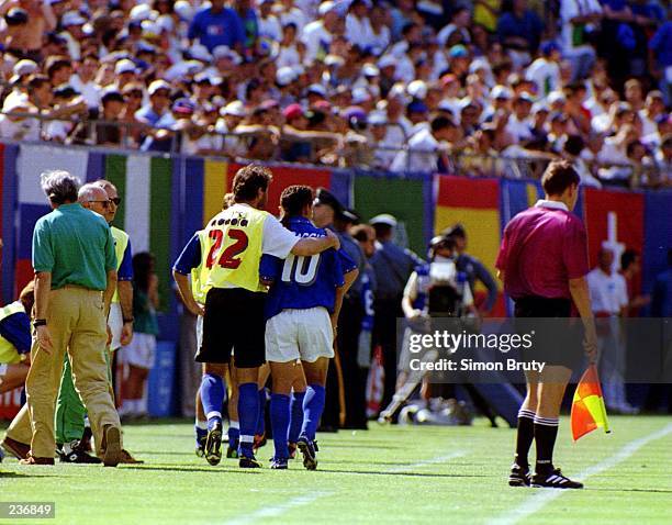 ROBERTO BAGGIO OF ITALY IS LED OFF THE FIELD AFTER BEING SUBSTITUTED DURING THE FIRST HALF AGAINST NORWAY IN THE 1994 WORLD CUP. BAGGIO CAME OFF TO...