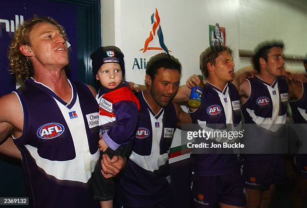 Shaun McManus of the Dockers holds his son as team mates Peter Bell, Byron Schammer # and Paul Hasleby sing the team song after their win at the...