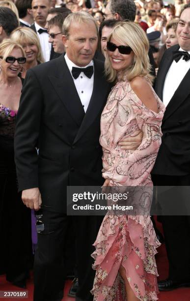 Actor Kevin Costner and girlfriend attend the premiere of The Matrix Reloaded at the 56th International Film Festival on May 15, 2003 in Cannes.