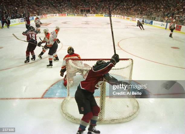 Joe Sakic, captain of the Colorado Avalanche, celebrates as he rounds the net after teammate Uwe Krupp scored in triple overtime to defeat the...