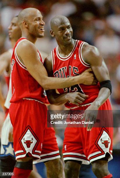 Ron Harper and Michael Jordan of the Chicago Bulls hug near the end of game 4 of the Eastern Conference Final between the Chicago Bulls and the...