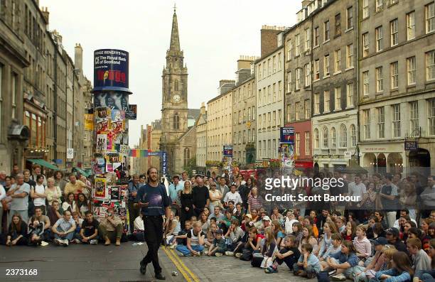 Street performer entertains the crowd during the 57th Edinburgh Festival Fringe August 5, 2003 in Edinburgh, Scotland. The festival is the world's...